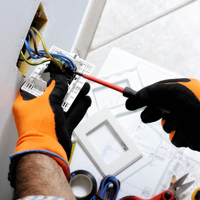 electrician installing outlet